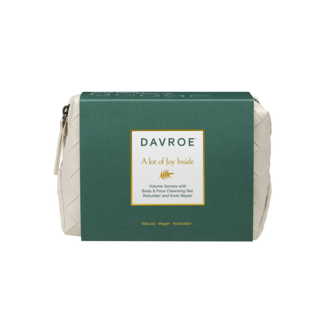 Davroe 'A lot of Joy Inside' body & facial cleansing gel in a cream-colored woven pouch with a dark green cardboard sleeve, shown on a plain white background.