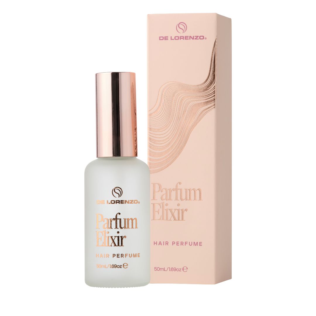De Lorenzo Parfum Elixir Hair Perfume bottle with a metallic rose gold cap next to its matching pink and beige packaging box, on a solid white background.
