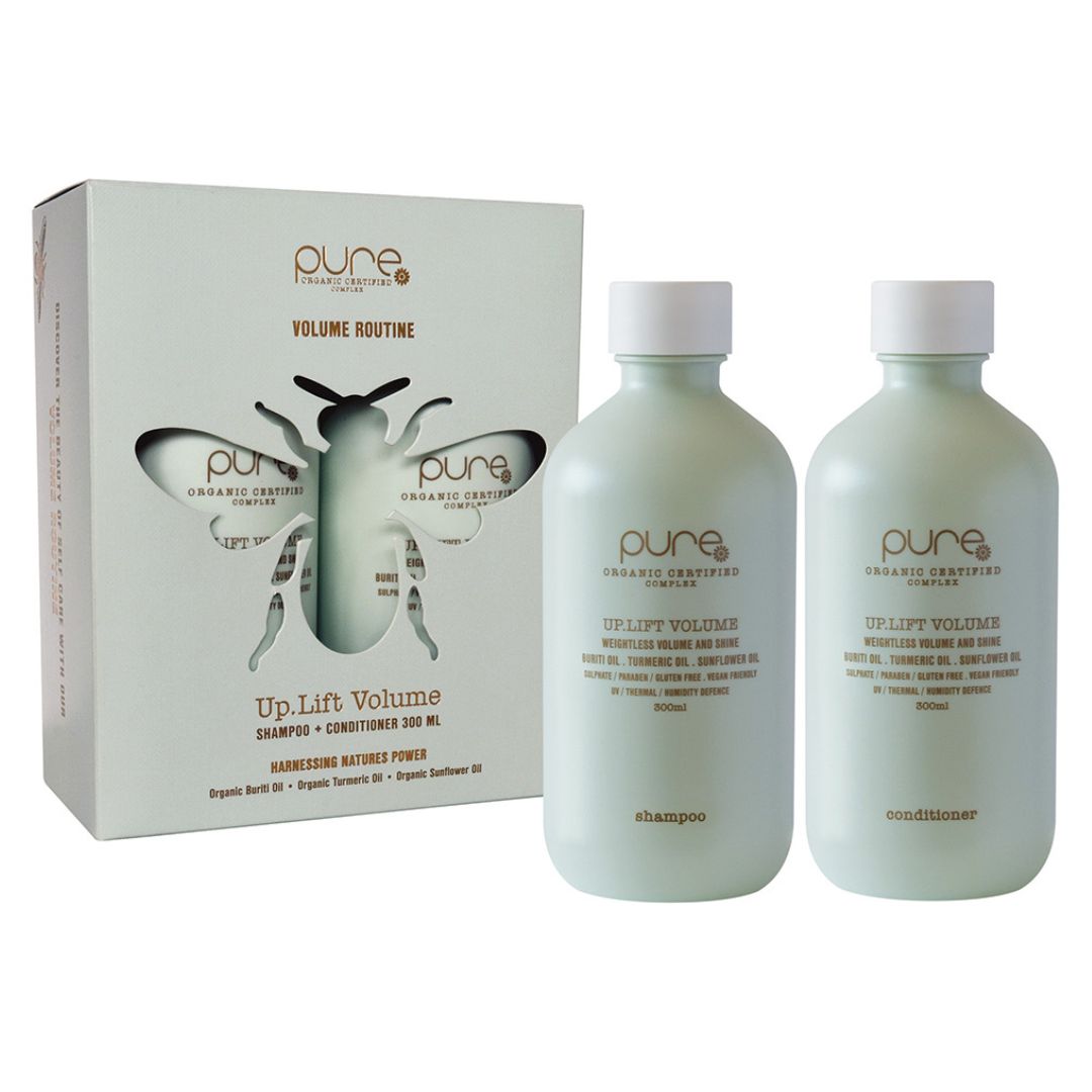 Two bottles of 'pure' shampoo and conditioner with a packaging box on a white background