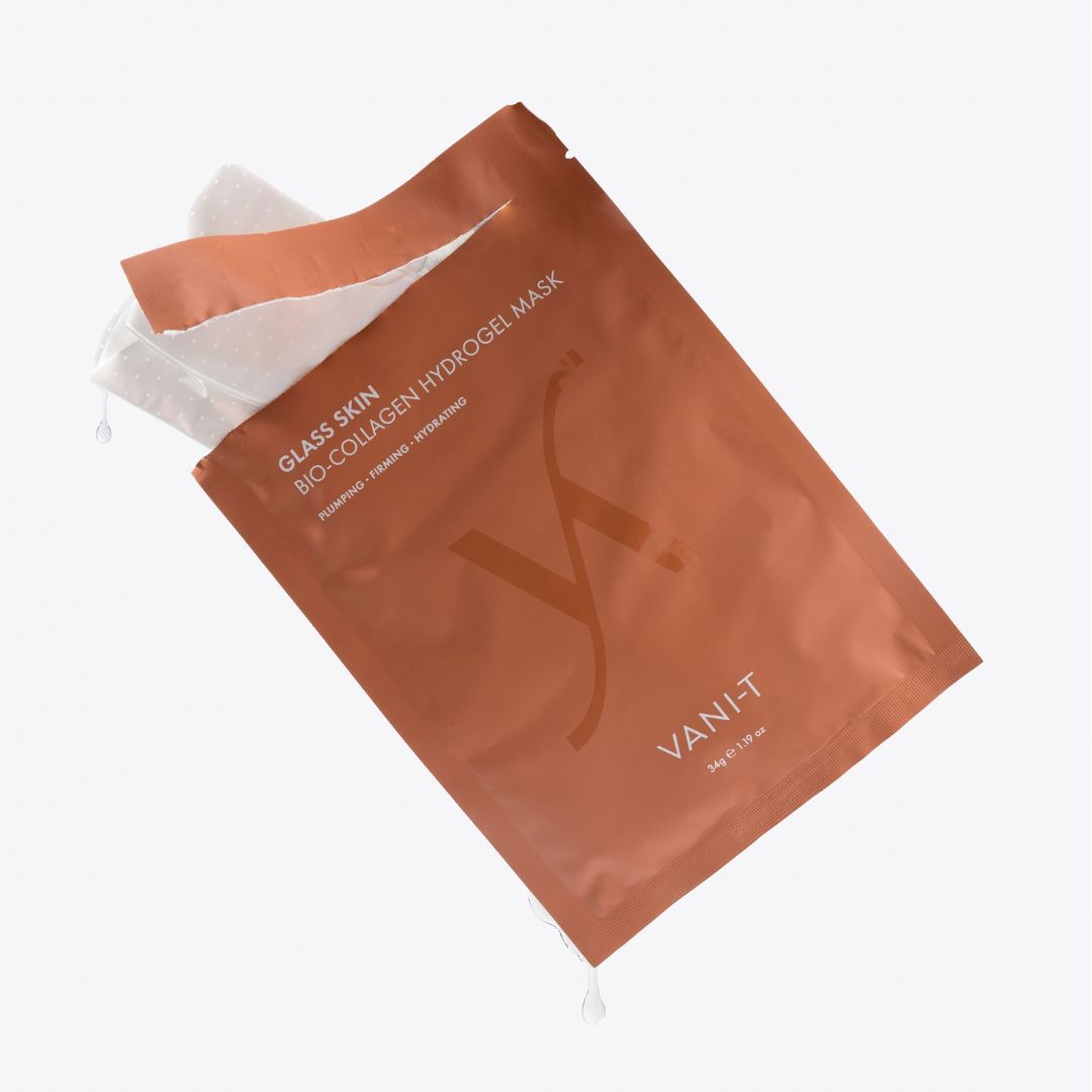 Vani-T Glass Skin Bio-Collagen Hydrogel Mask in a metallic copper-orange pouch, shown partially opened on a clean white background.