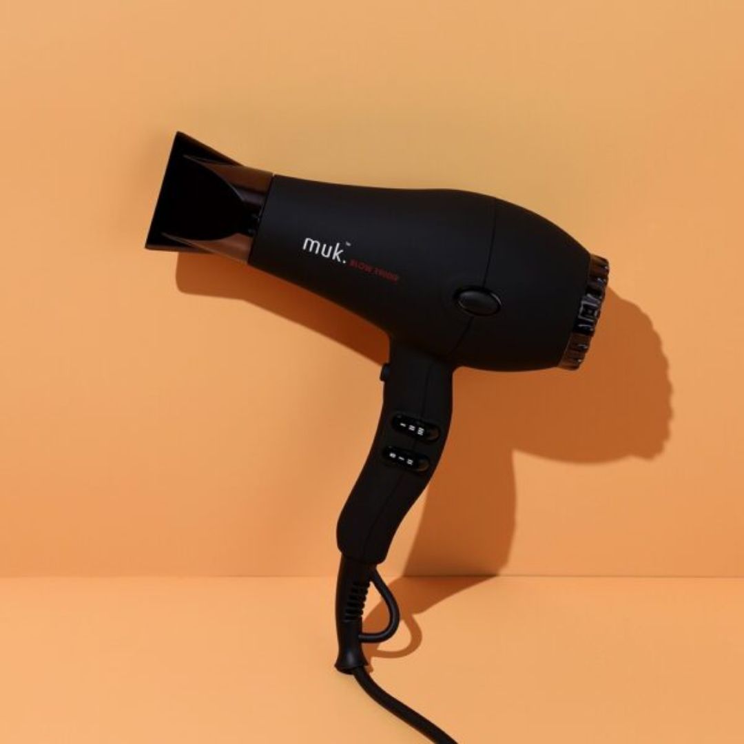 Black hair dryer with 'muk.' branding on an orange background