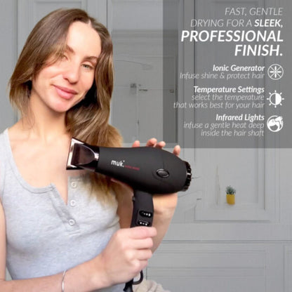 Woman holding a black hair dryer with text about its features on a gray background