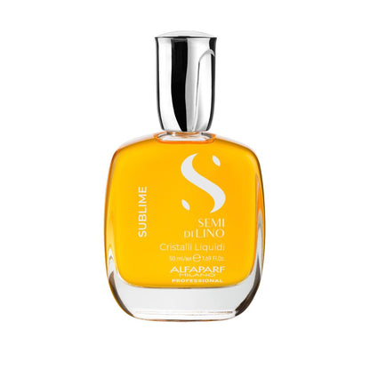 A bottle of Alfaparf SUBLIME Semi di Lino Cristalli Liquidi hair crystals, featuring a clear glass bottle filled with golden-yellow liquid and topped with a reflective silver cap, set against a plain white background.