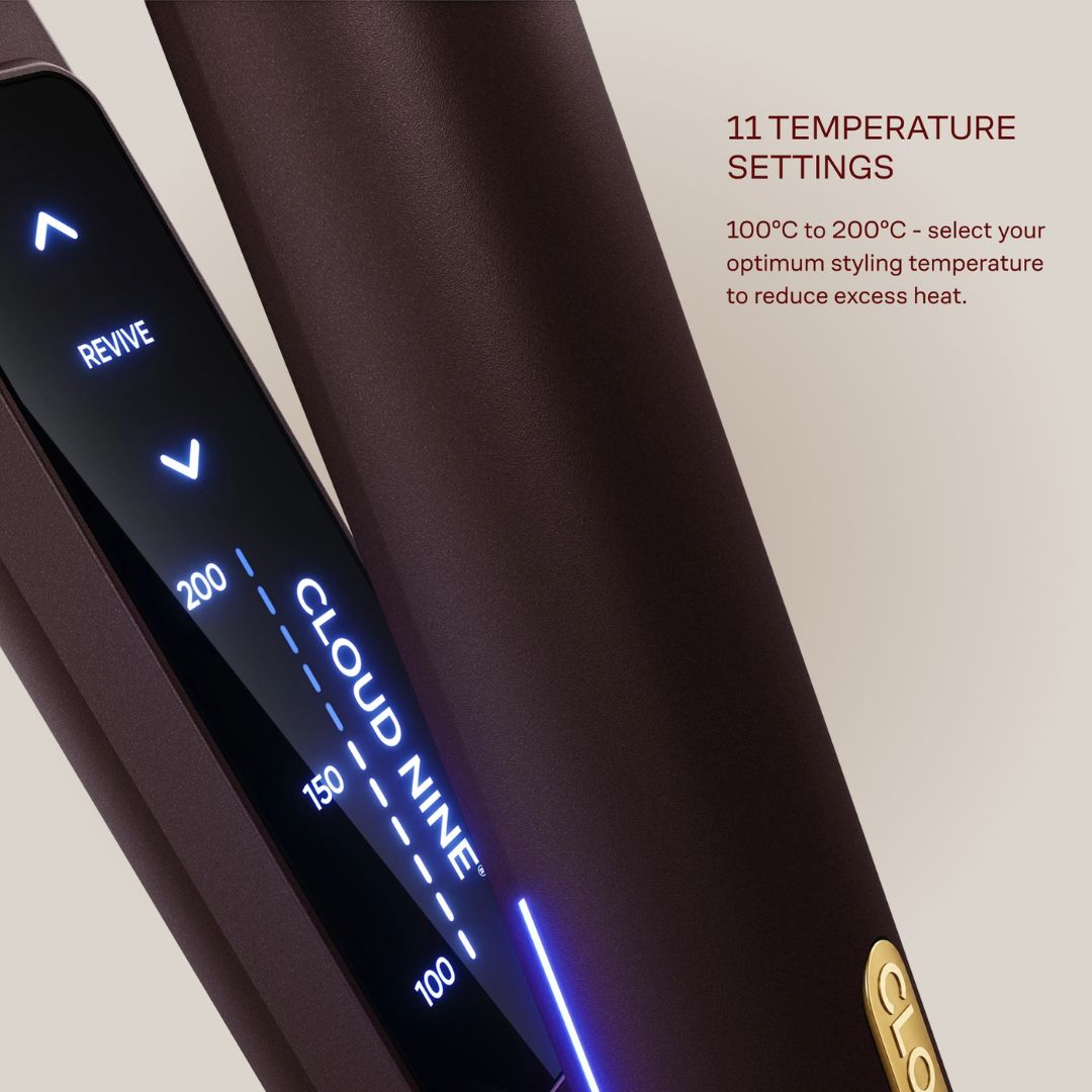 Close-up of a dark brown hair straightener showing its digital temperature display screen, with text on the right detailing 11 temperature settings and heat range.