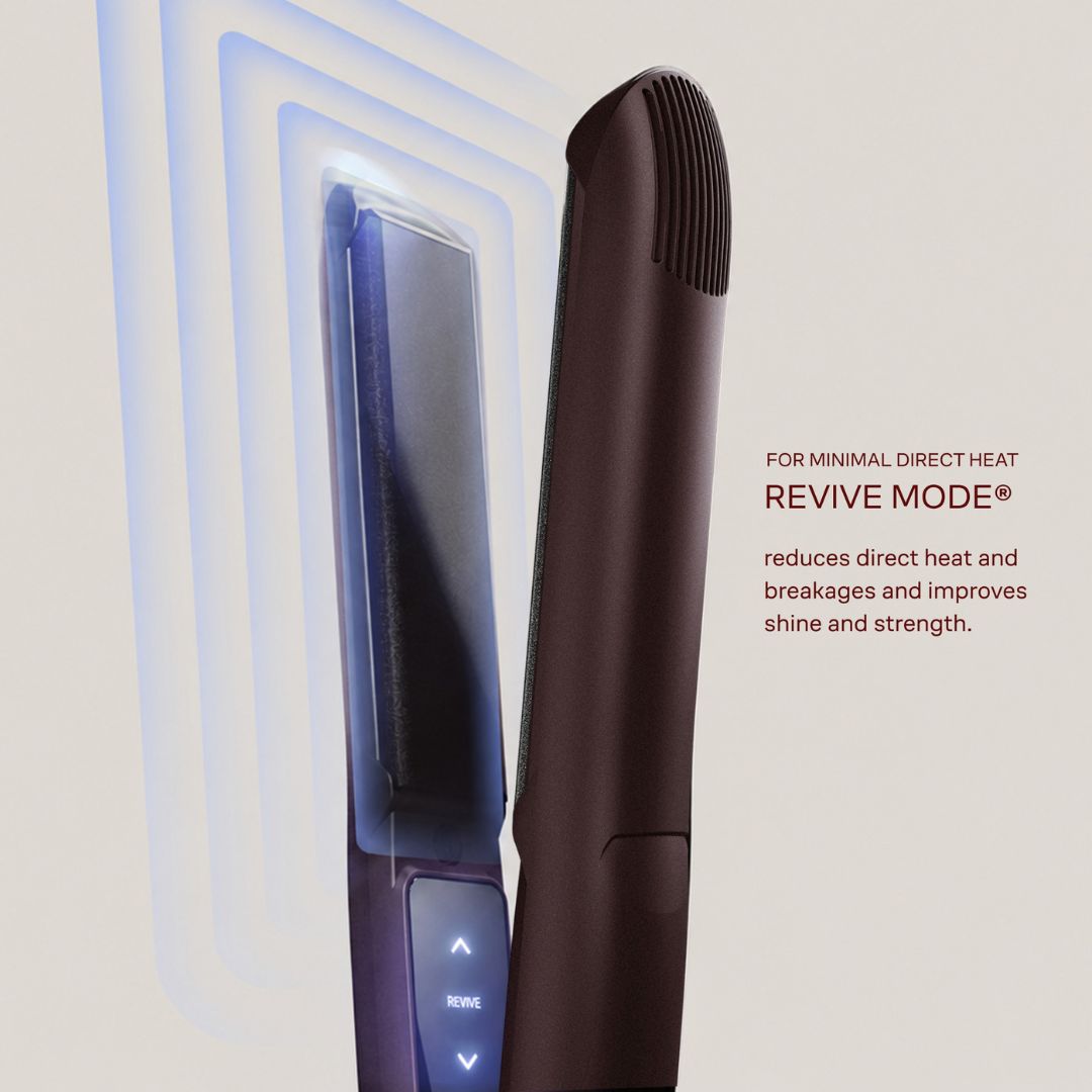 A dark brown hair straightener shown in a close-up product graphic with blue heat-zone lines and text reading 'FOR MINIMAL DIRECT HEAT REVIVE MODE® reduces direct heat and breakages and improves shine and strength.'.