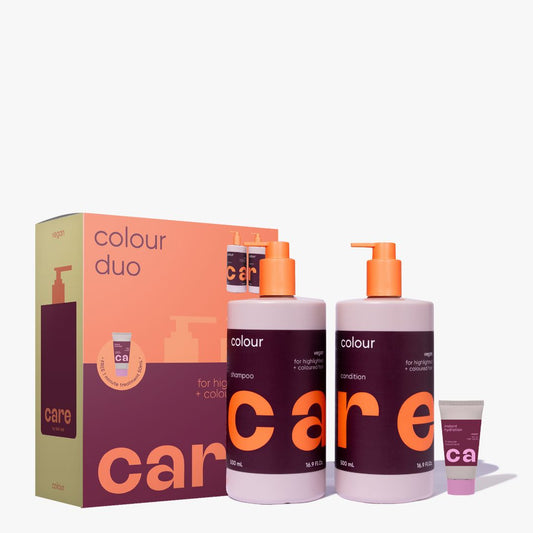A hair care set featuring two large bottles of shampoo and conditioner with orange pumps, a matching small tube, and a branded box. The packaging uses a color-blocked design in peach, dark purple, and beige, with the brand name 'care' prominently visible.