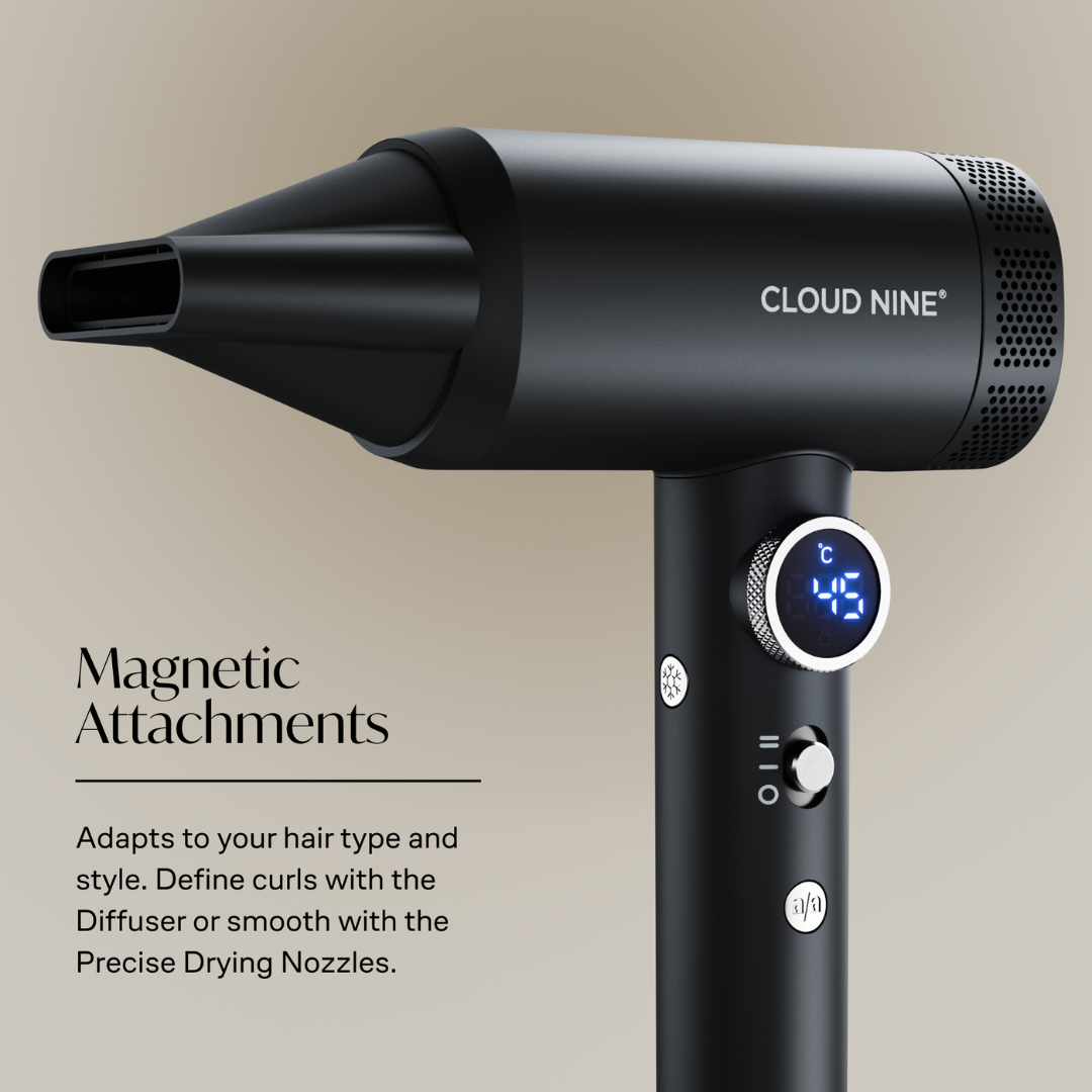 Black Cloud Nine hair dryer with a concentrator nozzle, digital temperature display, and control buttons, shown with text highlighting magnetic attachments on a warm beige background.