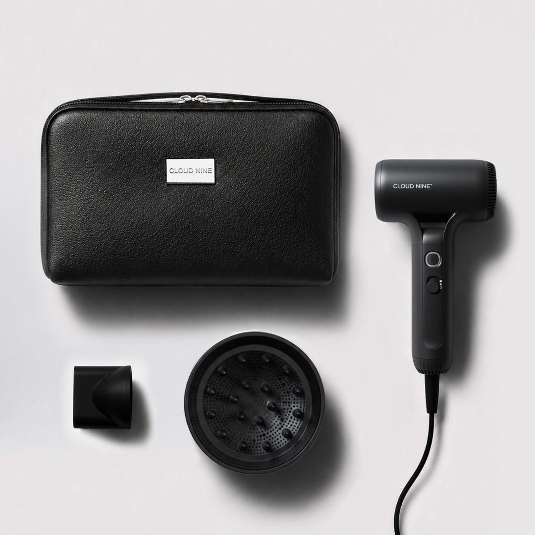 Cloud Nine hair dryer set with a black textured zippered carrying case, black concentrator nozzle, and black diffuser attachment, arranged on a light gray background.