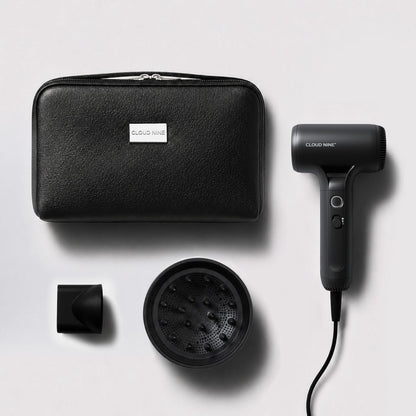 Cloud Nine hair dryer set with a black textured zippered carrying case, black concentrator nozzle, and black diffuser attachment, arranged on a light gray background.