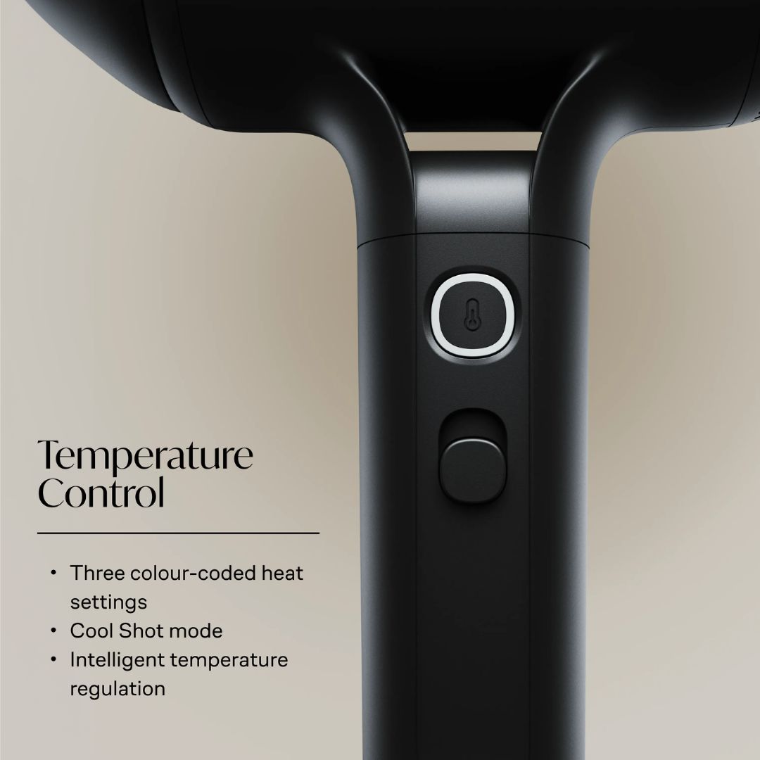 Close-up of a black hair dryer handle showing the temperature control panel with a power button and a second button below, alongside text describing temperature control features.