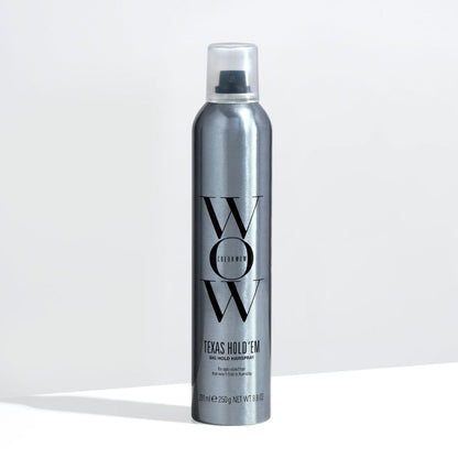 Silver hair spray bottle with 'WOW' branding on a light gray background