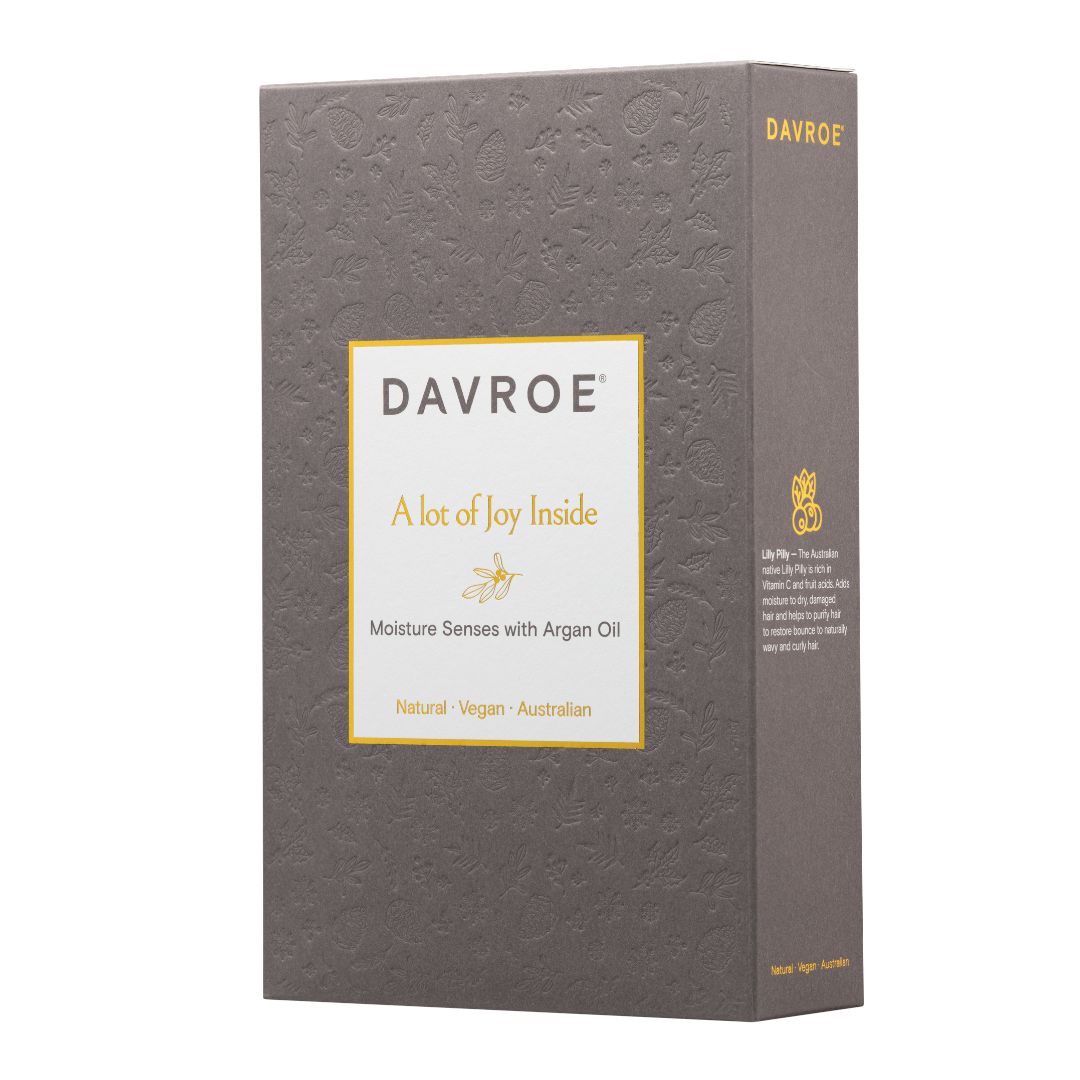 A tall rectangular product box for Davroe, shown on a plain white background. The box is dark gray with a subtle embossed floral pattern, a large white front label with gold border and text, and gold branding on the top and side.