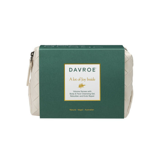 Davroe 'A lot of Joy Inside' body & facial cleansing gel in a cream-colored woven pouch with a dark green cardboard sleeve, shown on a plain white background.