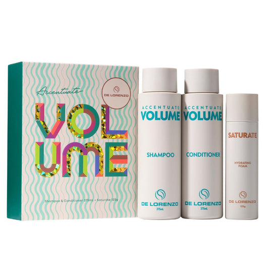 De Lorenzo's Accentioute Volume hair care set, including a colorful patterned box, a 250ml shampoo bottle, a 150ml conditioner bottle, and a 100ml Saturate hydrating foam bottle, all on a white background.