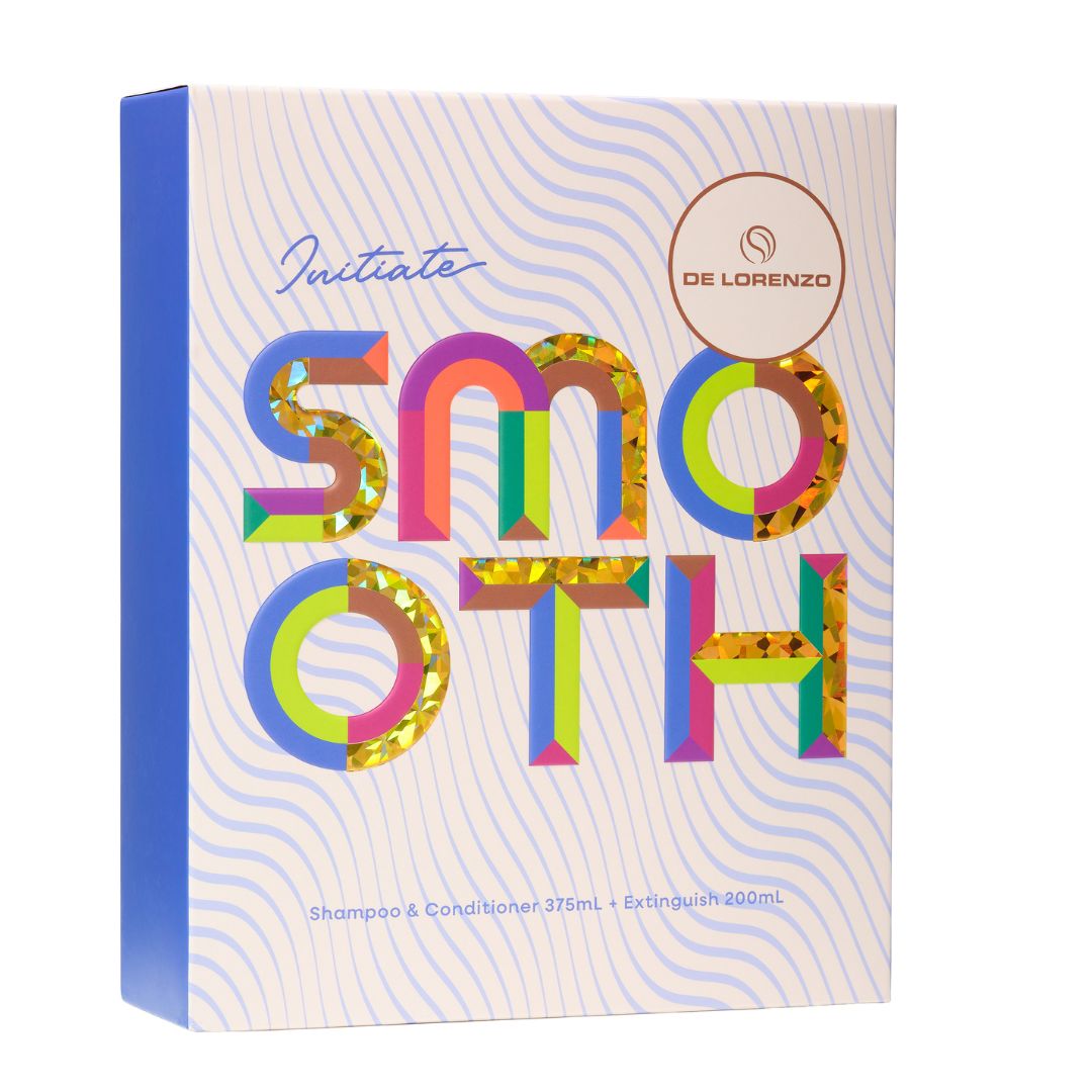 De Lorenzo Initiate Smooth shampoo and conditioner box, featuring a white and light blue wavy patterned design with large, colorful glitter-textured letters spelling 'SMOOTH' and a blue spine.