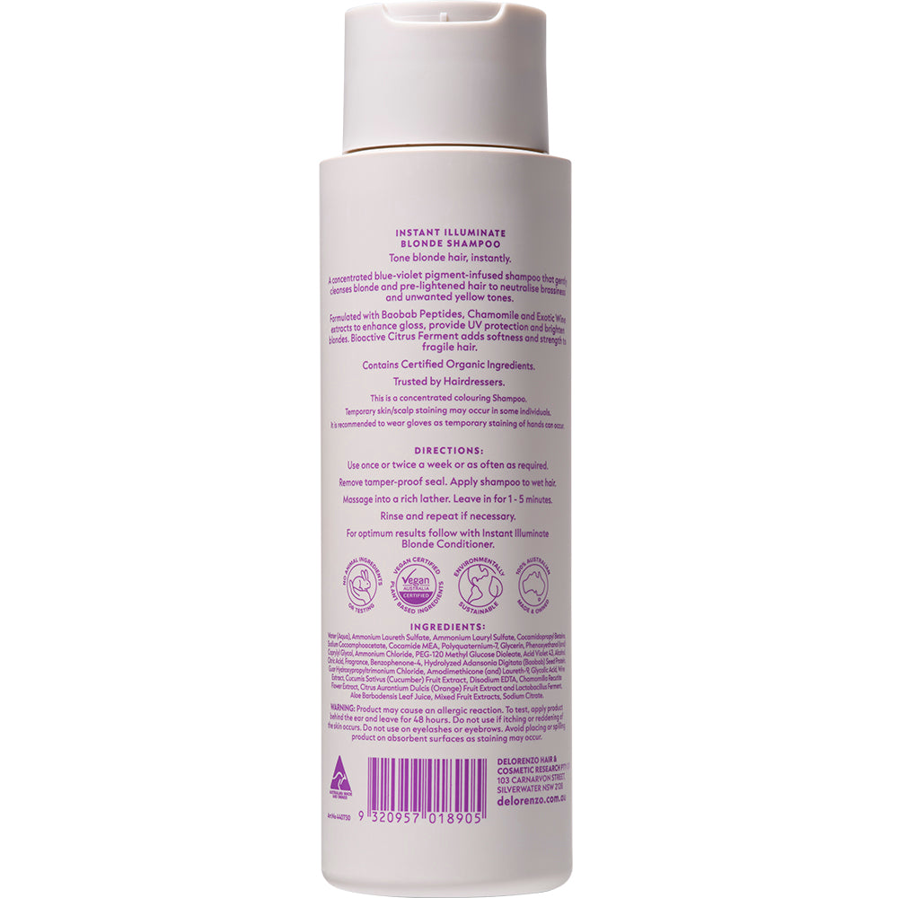 A bottle of Instant Illuminate Blonde Shampoo shown from the back, featuring a white bottle with a beige cap and purple text detailing the ingredients, instructions, and barcode.