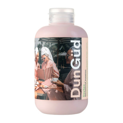 Pink bottle with a label featuring people at a beach, branded 'DunGud'.