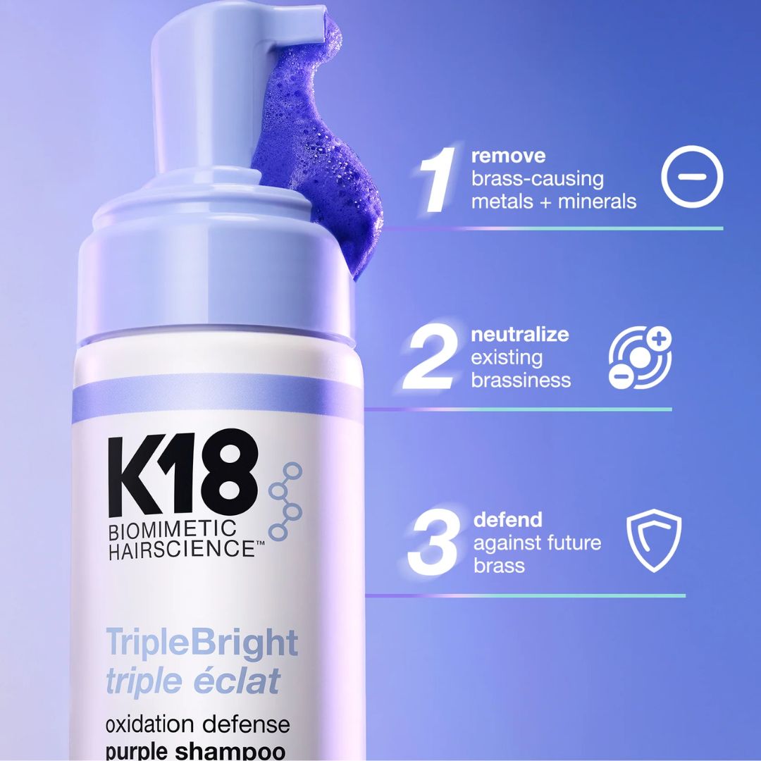 K18 shampoo bottle with purple shampoo on a blue background