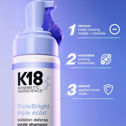 K18 shampoo bottle with purple shampoo on a blue background