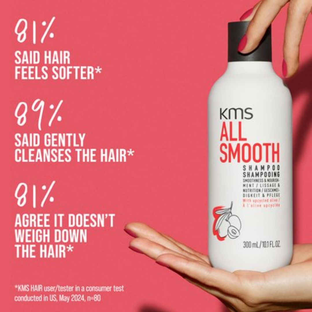 KMS All Smooth shampoo bottle held by a hand with product features on a red background