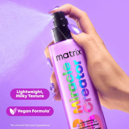 Hand holding a bottle of Matrix Miracle Creator with purple background