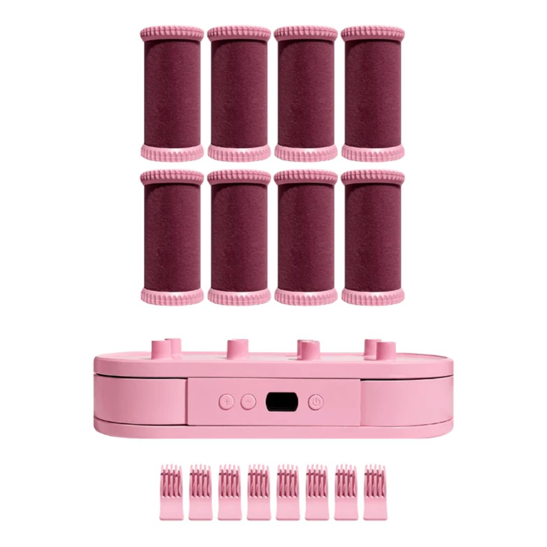 Pink hair styling device with interchangeable rollers on a white background