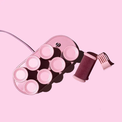 Hair roller set with pink rollers and brown handle on a pink background