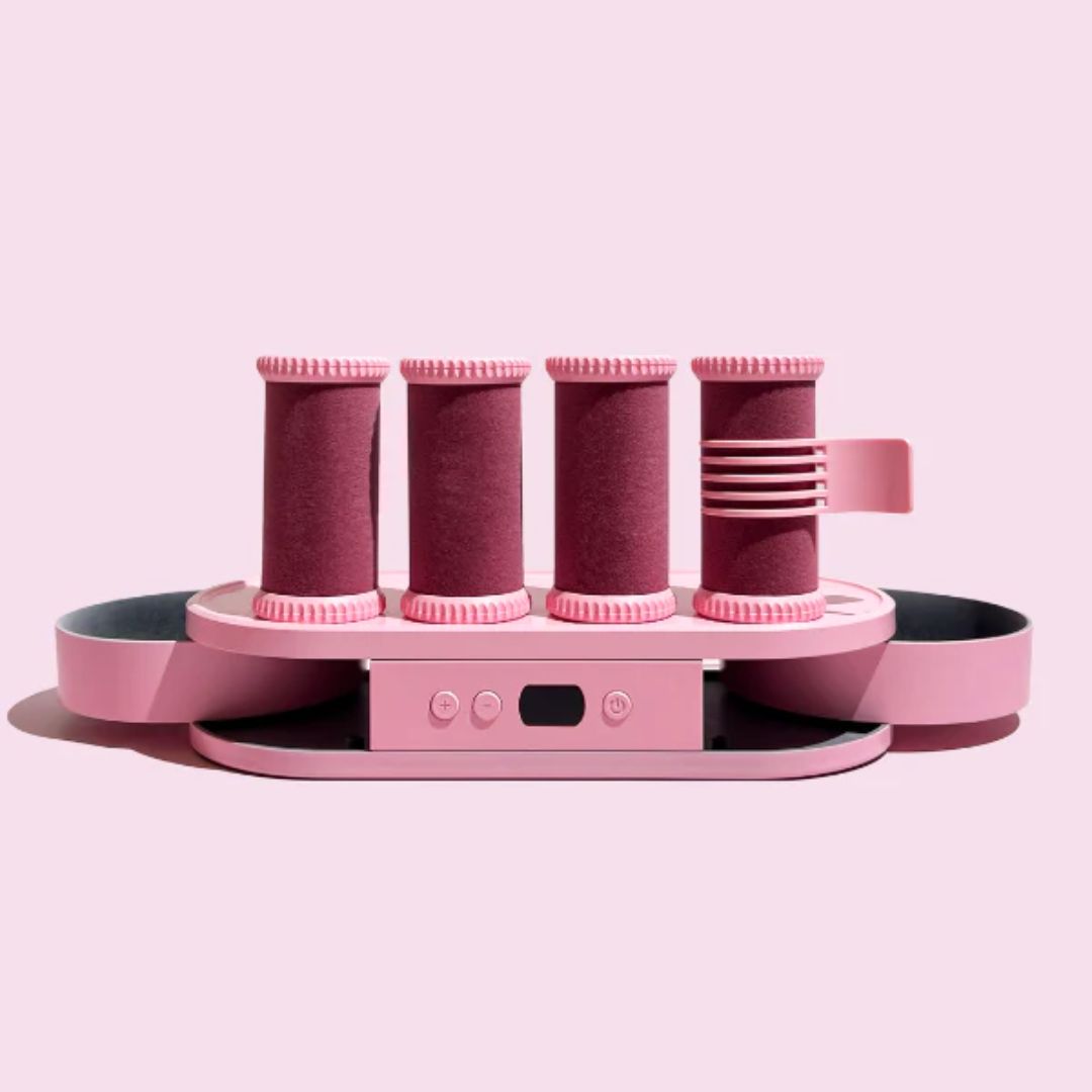 Pink hair roller set on a light pink background