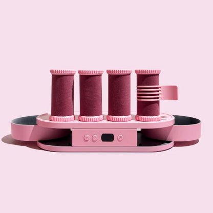 Pink hair roller set on a light pink background