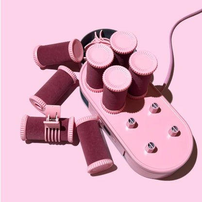Pink hair curler set on a pink background