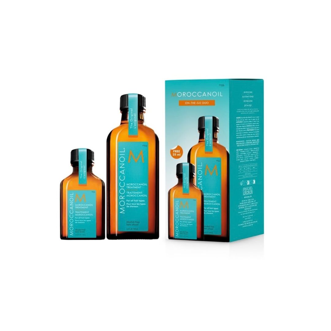 Three Moroccanoil hair oil bottles in amber glass with turquoise labels and black caps, shown alongside a matching turquoise product box on a white background.