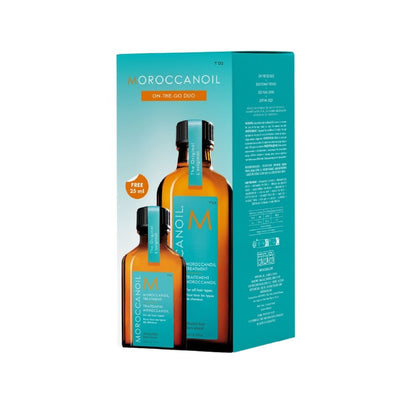 Moroccanoil On The Go Duo set, featuring a turquoise and orange product box with two amber glass bottles of shampoo and conditioner, shown on a plain white background.