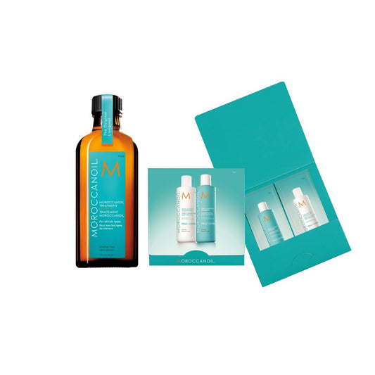 Moroccanoil hair care products including a bottle and two smaller bottles in a teal box on a white background.