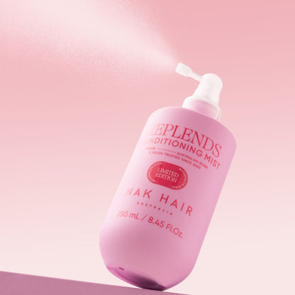 Pink bottle of Replends Conditioning Mist on a pink background