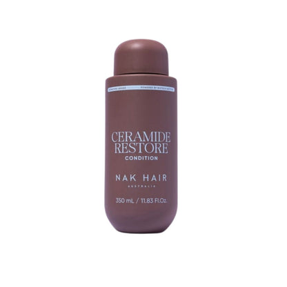 A bottle of Nak Hair Ceramide Restore Condition hair care product in a matte dark brown color, shown against a plain white background.