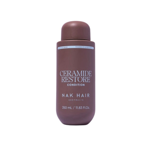 A bottle of Nak Hair Ceramide Restore Condition hair care product in a matte dark brown color, shown against a plain white background.