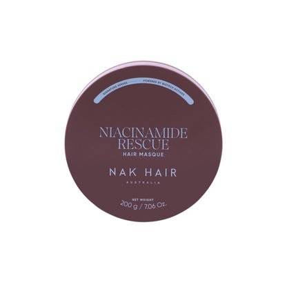 A round tin of Niacinamide Rescue Hair Masque by NAK HAIR, featuring a dark plum-brown lid with white and light blue text, set against a plain white background.