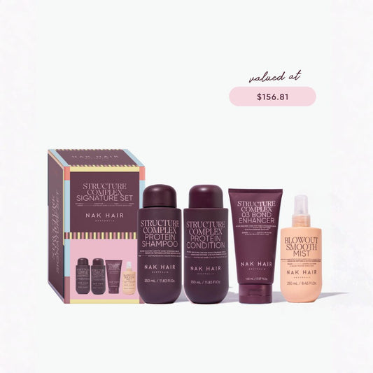 Nak Hair Structure Complex Signature Set hair care bundle including protein shampoo, conditioner, hair builder, and blowout smooth mist, displayed with its packaging box on a clean white background with a 'valued at $156.81' badge.
