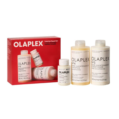 Olaplex hair repair set including a red retail box and four white bottles of hair care products on a plain white background.