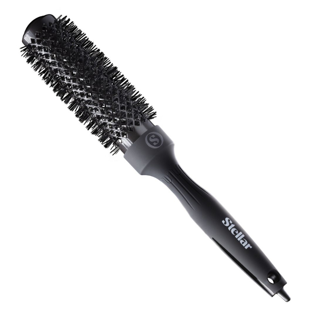 Black round hairbrush with bristle head on a white background, branded 'Stellar'.