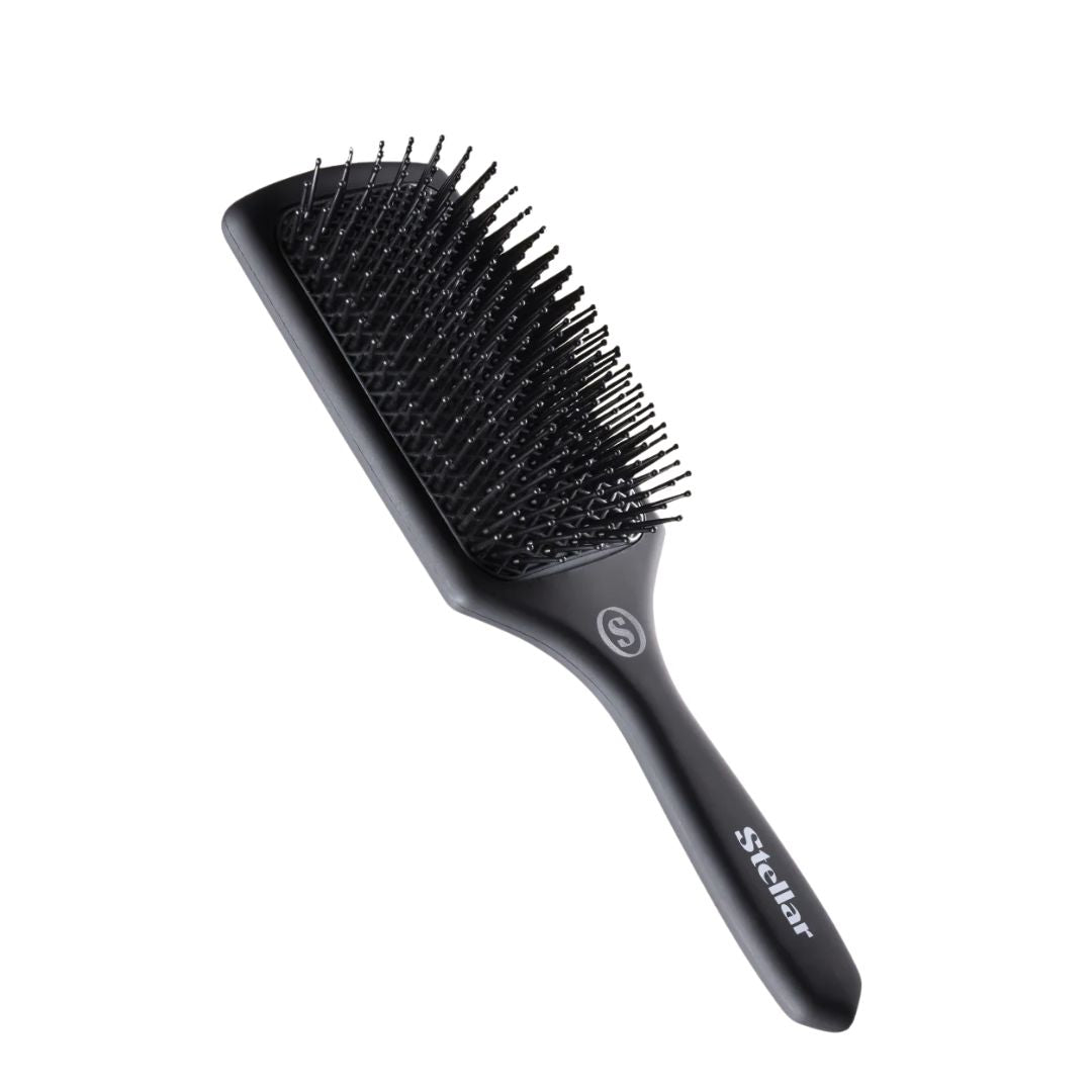 Black hairbrush with bristle head on a white background