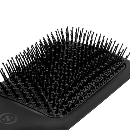 Black hairbrush with bristles on a white background