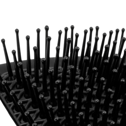 Black hairbrush with bristles on a white background