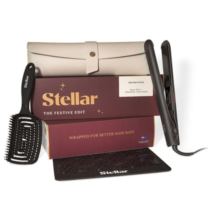 Stellar The Festive Edit hair care gift set featuring a black flat iron, black hair brush, beige storage case, and maroon gift box on a white background.