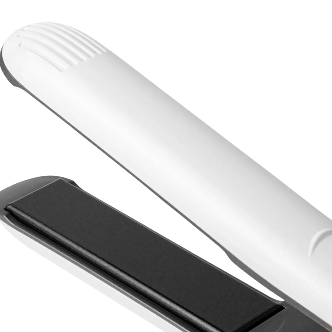 Close-up of a white electronic device with a black component on a white background