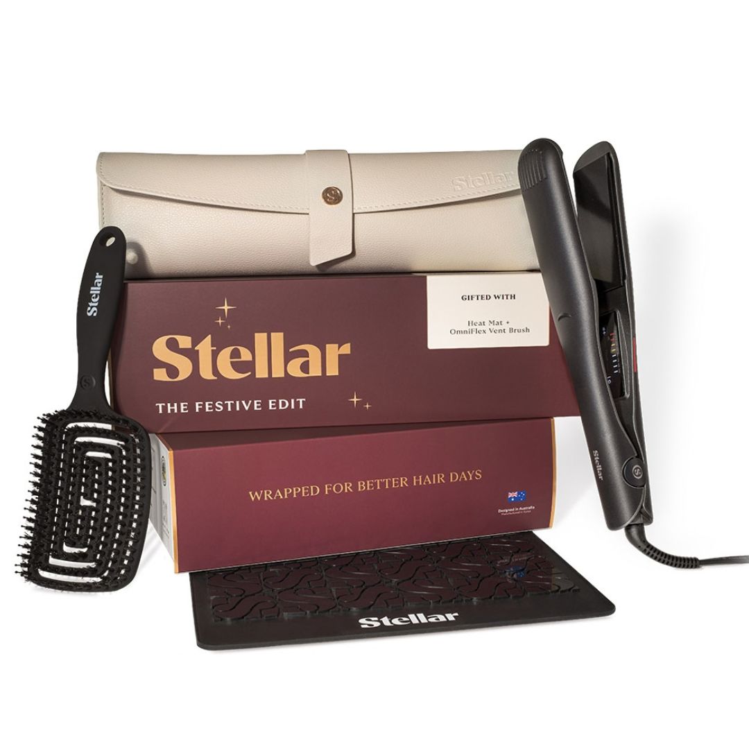 Stellar The Festive Edit hair care set including a black flat iron, black brush, black styling brush, and a beige travel case, displayed with branded boxes on a white background.