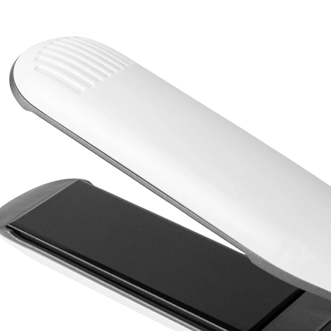 Close-up of a white electronic device with a black component on a white background