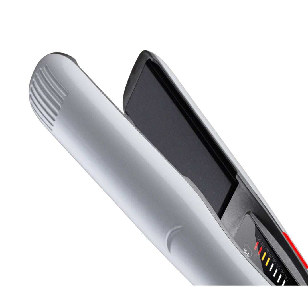 Silver hair straightener with digital display on a white background