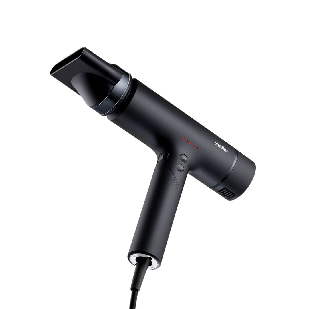 Black hair dryer with nozzle attachment on a white background