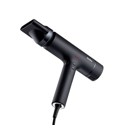 Black hair dryer with nozzle attachment on a white background